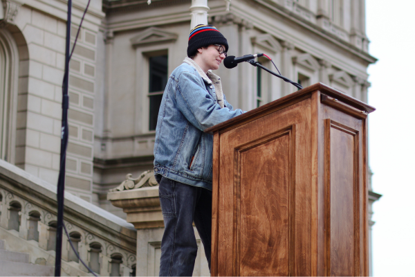 Andi Nations talking at the podium during the rally.